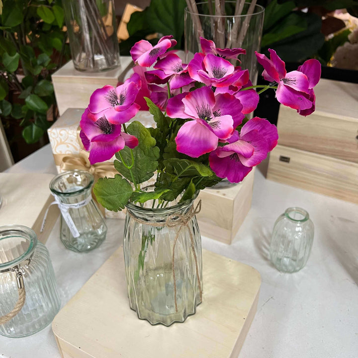 fuchsia pansy in a glass vase