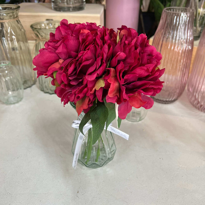 red peonies in vase